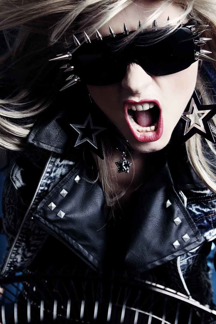 woman wearing black leather jacket black sunglasses with silver spikes